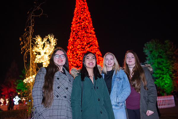 Friends pose in front of the central tree